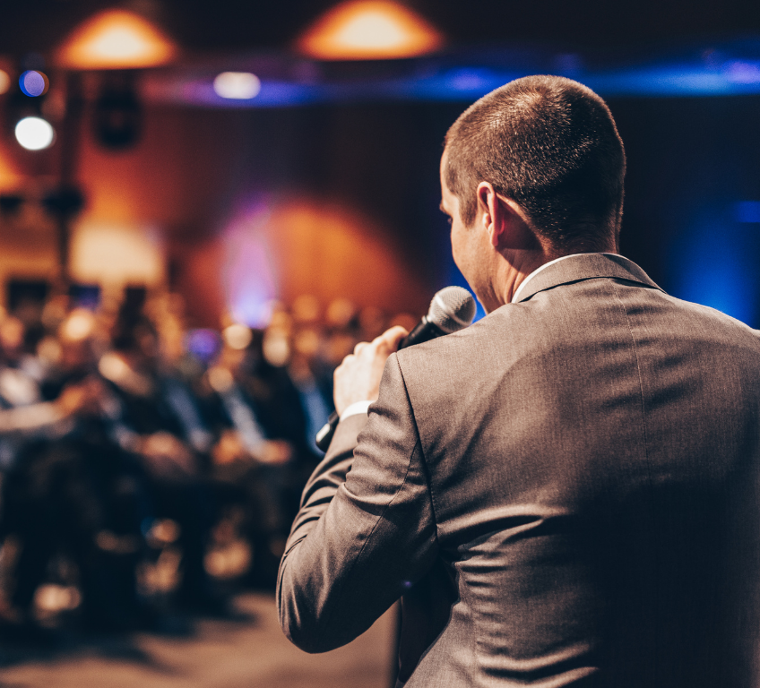 Speaker presenting to a live audience