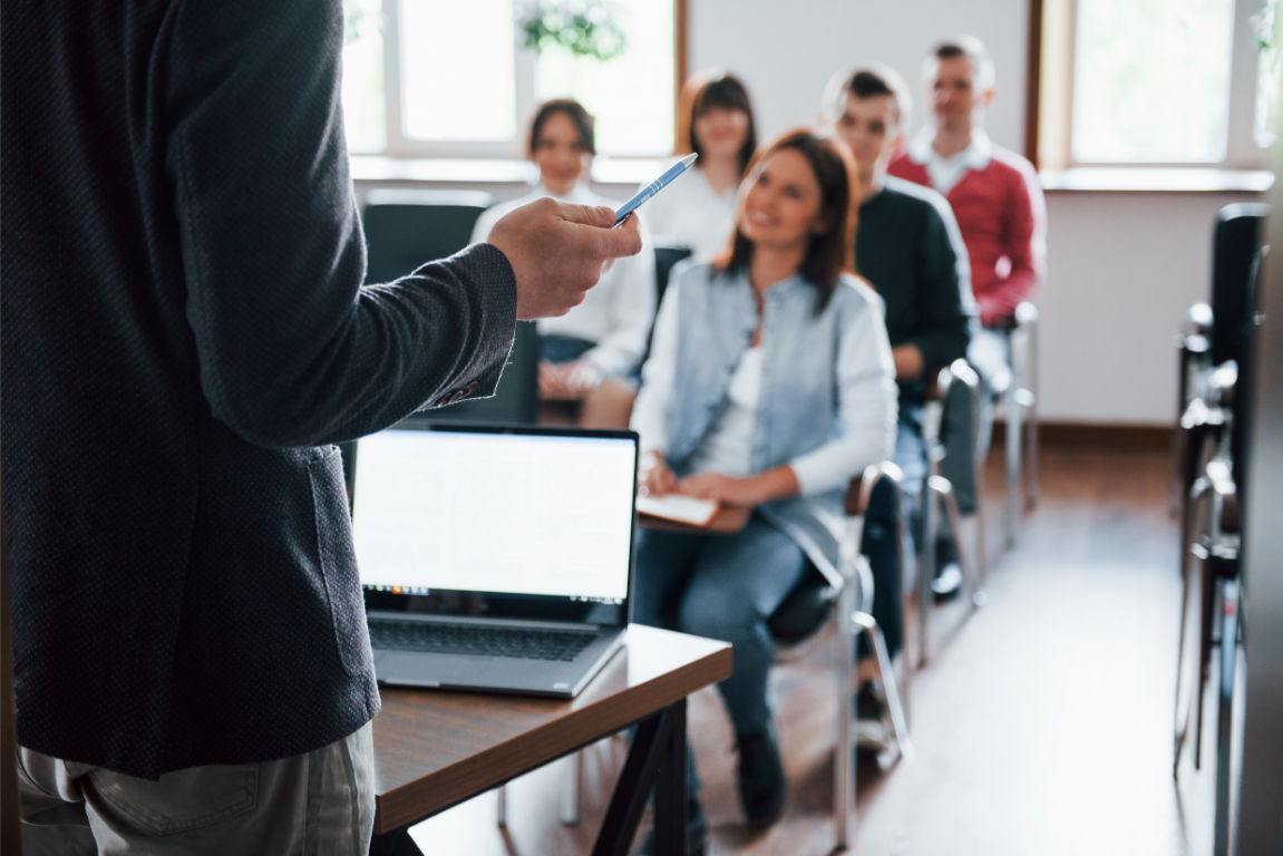 Trainer teaching a room of attendees