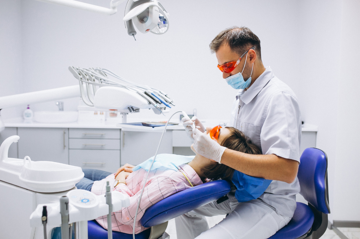Dentist treating a patient in a surgery