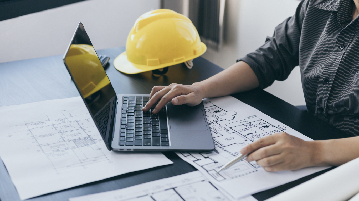 Architect reviewing plans on a laptop